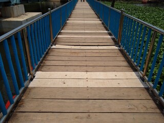 Fototapeta premium wooden bridge in the park, flotting pathway in Veli lake, Veli tourist village, Thiruvananthapuram Kerala