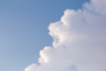 Soft white clouds in the close-up sky look dense, beautiful for background design, copy space available. Blue background