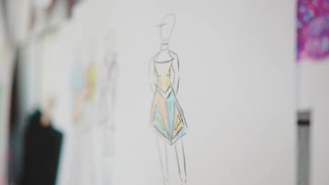 Tailor designer workspace. Close up of sketches and color swatch on visual board at tailor studio, tracking shot