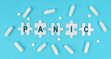 On a blue background, there are pills and puzzles with the inscription - PANIC