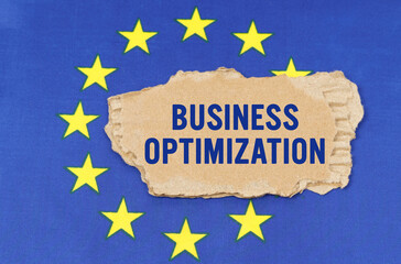 There is a cardboard box on the EU flag that says- BUSINESS OPTIMIZATION