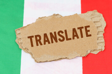 Against the background of the flag of Italy lies cardboard with the inscription - Translate