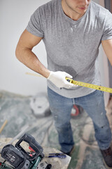 Young adult man working on a DIY budget renovation of his new home apartment.