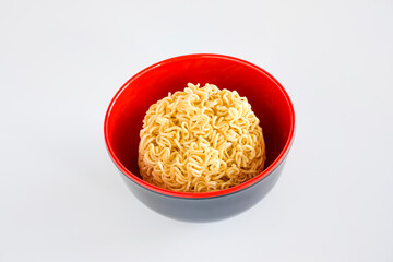 Yellow instant noodles in a red bowl