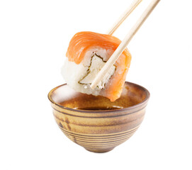 Sushi roll (Philadelphia) dipped in soy sauce