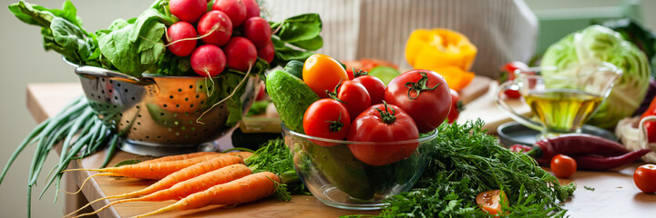 Concept of clean eating, organic healthy food, low calories meal, dieting, self caring lifestyle. Colorful fresh vegetables from the market, ingredients for light summer salad for lunch. Banner