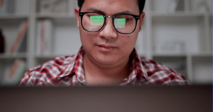 Young man scrolling to select products from catalog shopping online