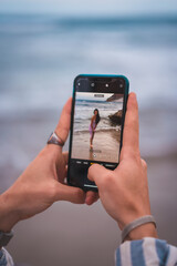 Photo of a brunette Caucasian with a pink fabric dress, on the beach in the sea enjoying the holidays
