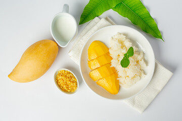fresh ripe mango and sticky rice with coconut milk on white background