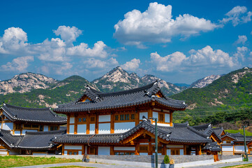 Fototapeta na wymiar Eunpyeong hanok village and have bukhansan mountain the back with blue sky and white clouds in seoul city south korea