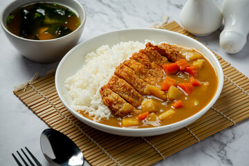fried pork cutlet curry with rice on dark background