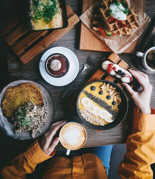 Breakfast in a cafe, Lifestyle photo top view in restaurant, Atmospheric food, Scrambled eggs, Bowl with mango, Waffles, Dranik