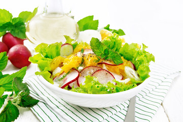 Salad of radish and orange with mint on board