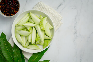 fresh green mango with sweet fish sauce dipping on white background