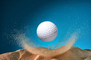 Selbstklebende Fototapeten golf ball flying through the sand © Loginov Sergei