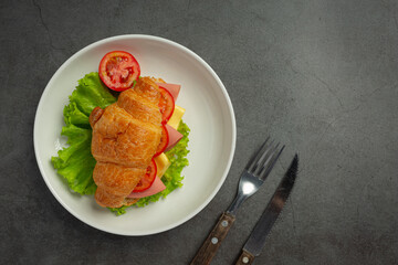 croissant sandwiches on dark wooden backgroud