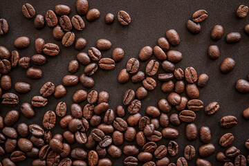 close up of roasted coffee beans on black background 