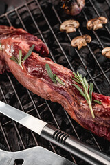 Raw fresh beef whole tenderloin with rosemary and mushrooms on black background
Grill accessories