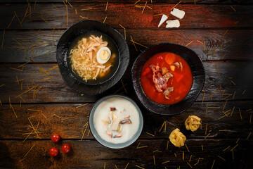 Soups on a dark wooden background