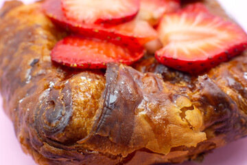 Puff pastry bun or roll. Cake with fresh strawberries. Delicious sweets temptation and desserts on...