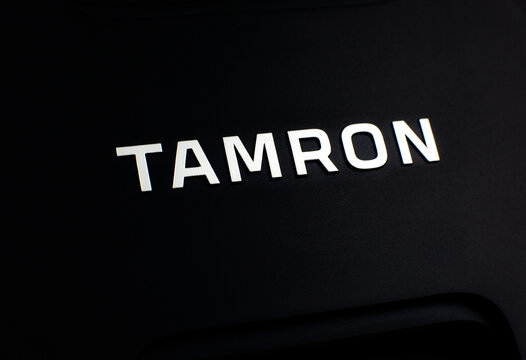 LVIV, UKRAINE - March 20, 2021 : Tamron camera lens. Brand label. close up.