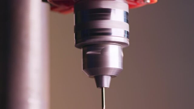 Slider pan shot of a drilling machine rotation at the workplace of a toolman locksmith