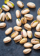 Roasted pistachios nuts on dark background. Healthy snack