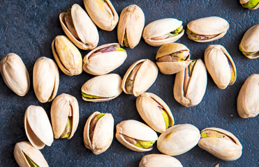 Roasted pistachios nuts on dark background. Healthy snack