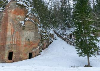 landscape with Anfabrikas rock Ligatne, artificial caves in the rock wall, all covered with snow, Ligatne, Latvia