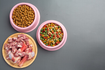 Healthy fresh pet food ingredients on dark background