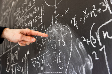 Mathematical formulas on dark black chalk board