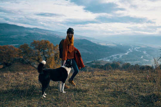 women walking next to the dog in nature landscape mountains travel