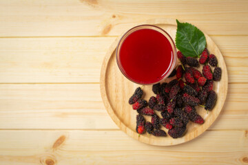 Mulberry juice on wooden backgroud