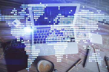 Business theme hologram drawings over computer on the desktop background. Top view. Multi exposure. Concept of international connections.