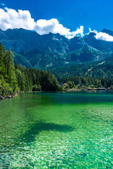 Faboulus landscape of Eibsee Lake with turquoise water in front of Zugspitze summit under sunlight. Location: Eibsee lake, Garmisch-Partenkirchen Bavarian alps, Germany, Europe