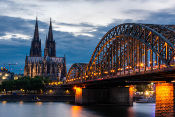 Fototapeta premium COLOGNE, GERMANY, 23 JULY 2020 Colorful sunset over Cologne Cathedral and Hohenzollern Bridge