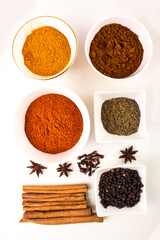 spices in ceramic bowls and white background stock photo