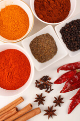 Spices: Turmeric, pepper and red chilly, etc,. shot from above on white background stock photo