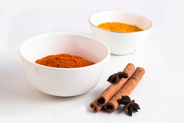 Spices: Turmeric,Chilly powder in ceramic bowls on white background stock photo