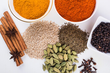  spices in ceramic bowls and on ground With white background stock photo