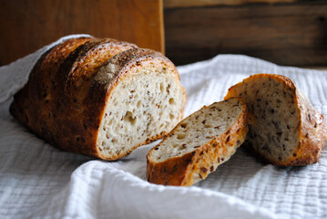 Fresh aromatic bread lies on a white napkin.