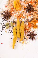 Spices: Turmeric, Chilly powder, Cardamom and anise stars  on ground with white background stock photo