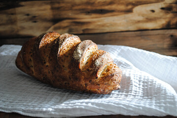 Fresh aromatic bread lies on a white napkin.