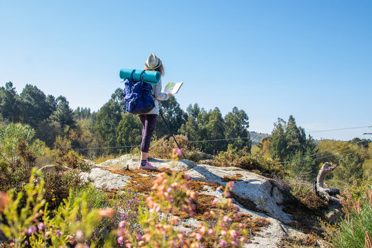 woman with backpack and map hiking