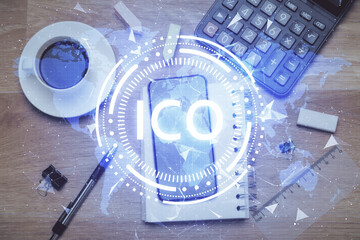 Double exposure of blockchain theme hologram over table with phone. Top view. Crypto technology...