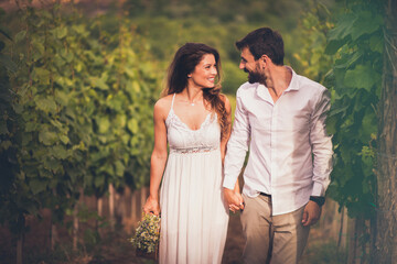 Fototapeta na wymiar Couple walking and talking in vineyard.