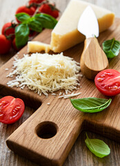 Grated parmesan with basil and tomatoes