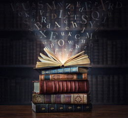 Old book with flying letters and magic light on bookshelf background in library. Ancient books as a symbol of knowledge, history, memory. Conceptual foundations of education, literary themes..