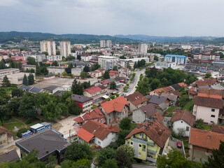 Fototapeta na wymiar Aerial view of Doboj downtown from medieval fortress Gradina during overcast summer day.