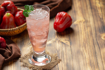 Rose apple juice on dark wooden backgroud